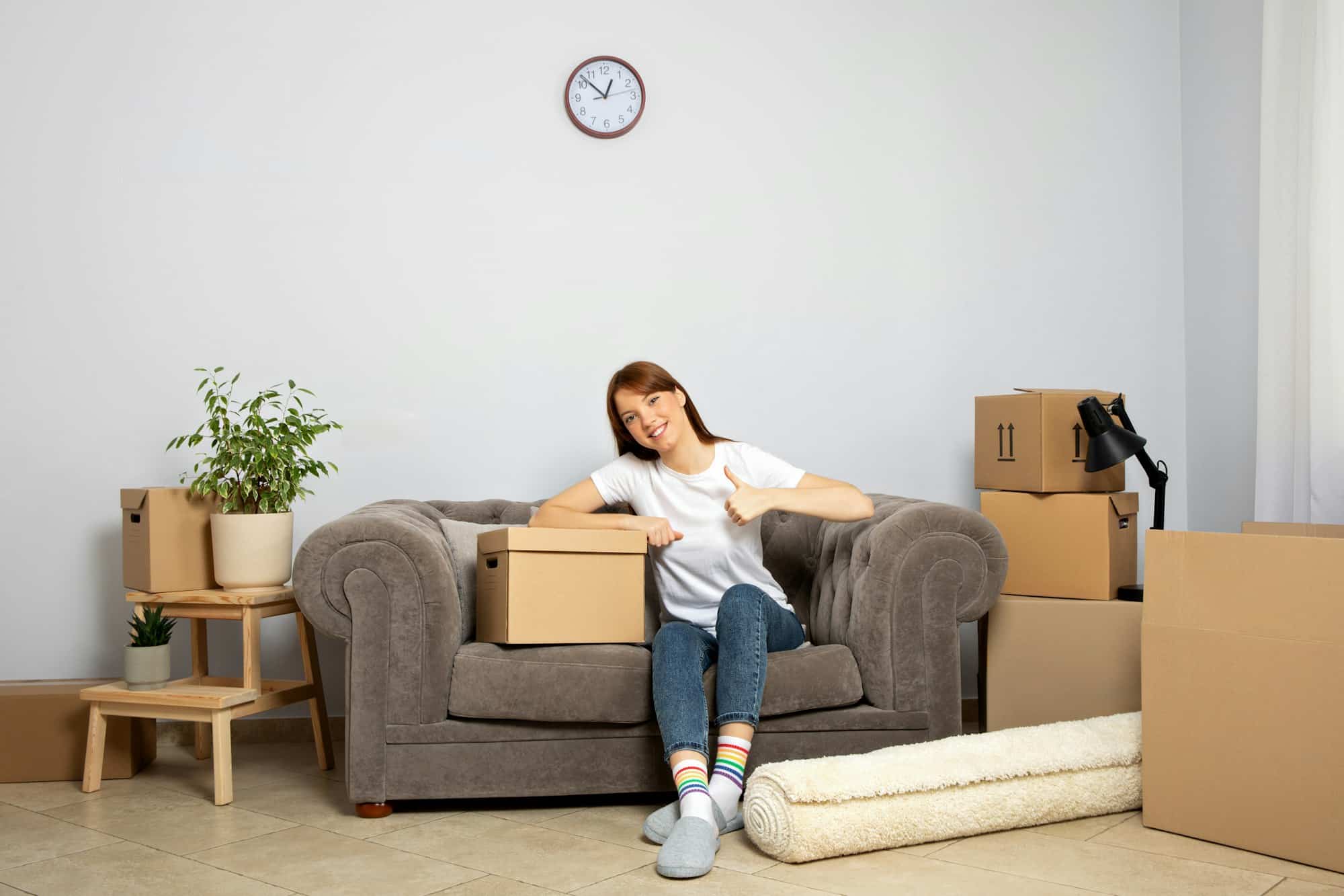 The concept of moving, a girl with boxes in an apartment.